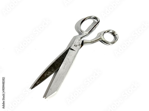 A single tailor cloth fabric scissors made from metal for sewing isolated on white background photo