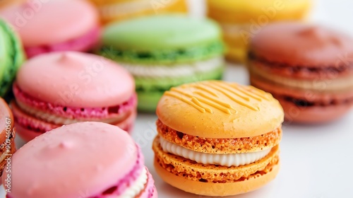 Brightly colored macarons with a glossy sheen, closeup, against a white background