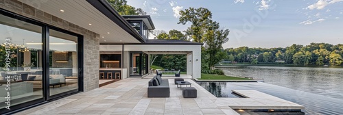 Modern lake house with large covered porch overlooking Lake Parker, featuring an ivory white and gray color palette with black accents, captured in natural light from the front yard showing the back  photo