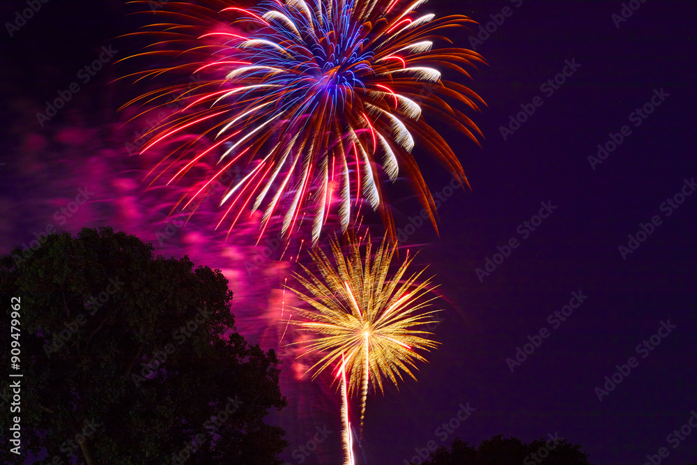 Purple night sky filled with colorful and beautiful fireworks celebrating the 4th of July Purple night sky filled with colorful and beautiful fireworks celebrating the 4th of July