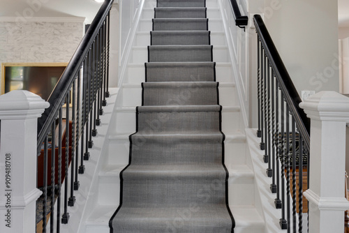 Modern Staircase With A Runner Carpet And Sleek Black Railing photo