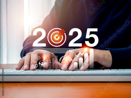 2025 business trend, market growth and technology concept. 2025 calendar number with AI assistance support tools, digital marketing data, strategy icons appear while businessman working with computer. photo