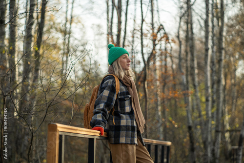 Wallpaper Mural Peaceful hiker woman on walk against of yellow, orange thicket, birch leaves foliage. Satisfied female having good time on stroll in nature, glad relaxed backpacker wandering outside with smile. Torontodigital.ca
