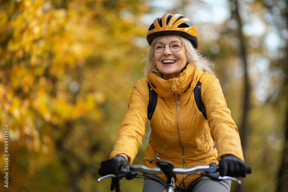 woman is smiling and riding a bicycle. She is wearing a yellow jacket and glasses. Concept of happiness and freedom, as the woman enjoys her time outdoors on her bike