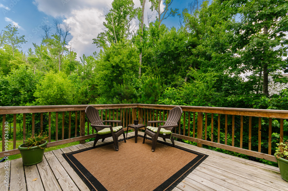 Calm Outdoor Deck With Chairs, Table, Plants, And Lush Green Forest View Calm Outdoor Deck With Chairs, Table, Plants, And Lush Green Forest View