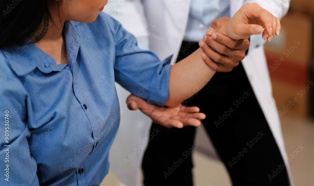 Fototapeta premium Doctor or Physiotherapist working examining treating injured arm of athlete male patient, stretching and exercise, Doing the Rehabilitation therapy pain in clinic.