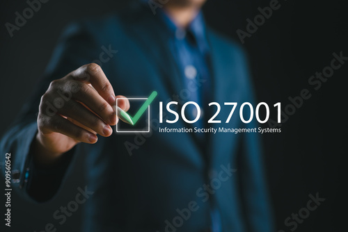 ISO 27001 concept. requirements, certification, management, standards. Businessman using tablet to choose ISO 27001 for information security management system (ISMS). photo