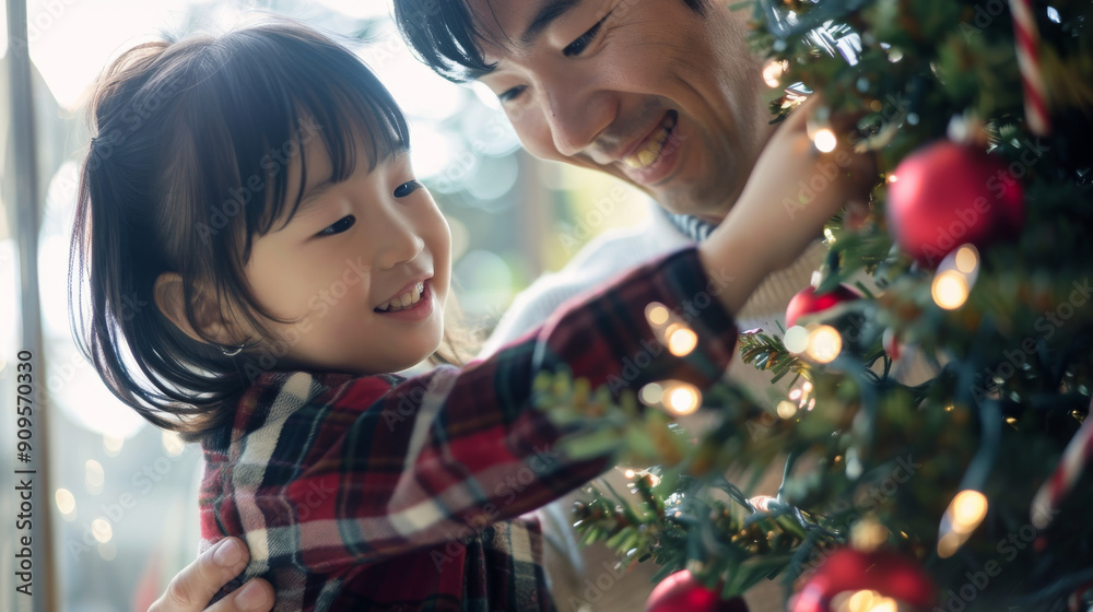 Φωτογραφία Happy Asian parent helping their Asian daughter decorate the house christmas tre
