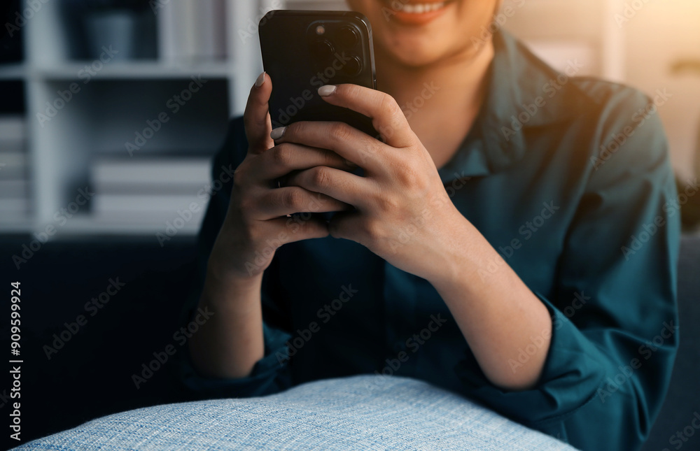 Charming young Asian woman using cellphone, communicating on web, working or learning online, sitting in armchair against white wall, free space. Lovely millennial lady chatting on smartphone Charming young Asian woman using cellphone, communicating on web, working or learning online, sitting in armchair against white wall, free space. Lovely millennial lady chatting on smartphone