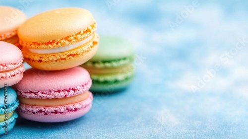 Delicious, colorful macarons are artistically arranged on a serene gradient background