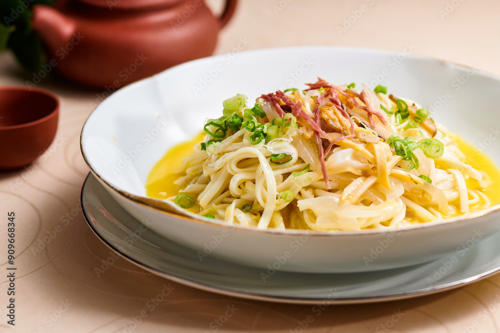 Yunzu seafood hand pulled noodles served in bowl isolated on table background side view of hong kong food Yunzu seafood hand pulled noodles served in bowl isolated on table background side view of hong kong food