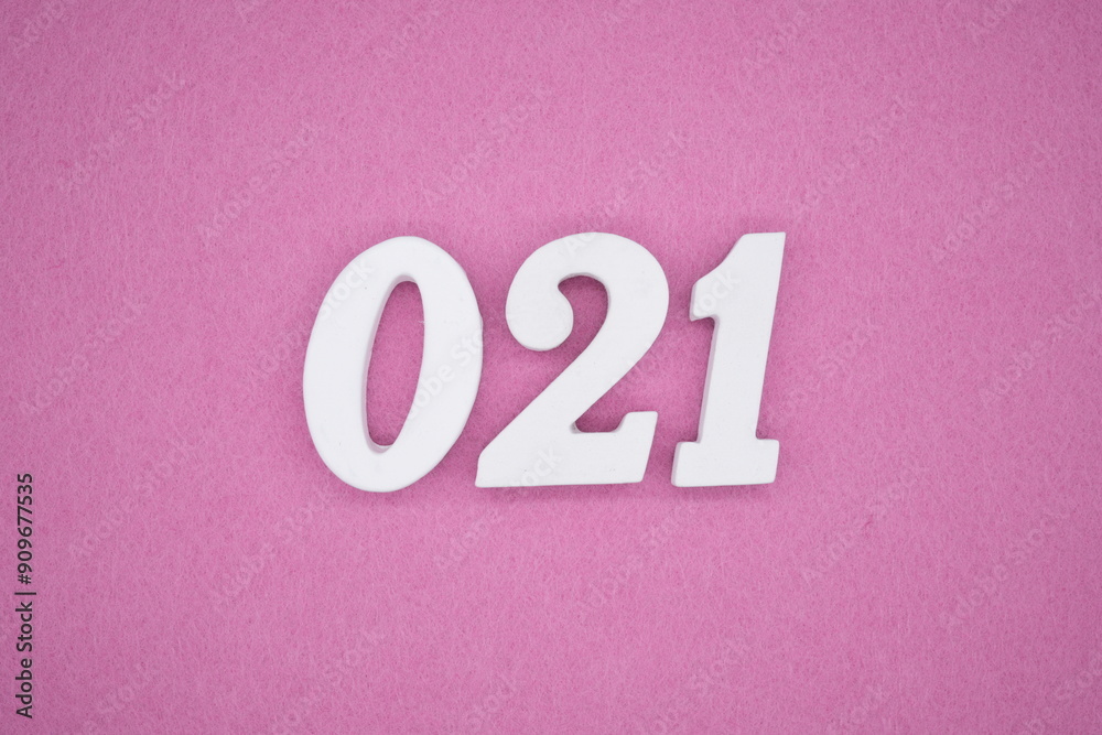 The numbers are made of white painted wood. Laying on the floor was pink paper. The numbers are made of white painted wood. Laying on the floor was pink paper.