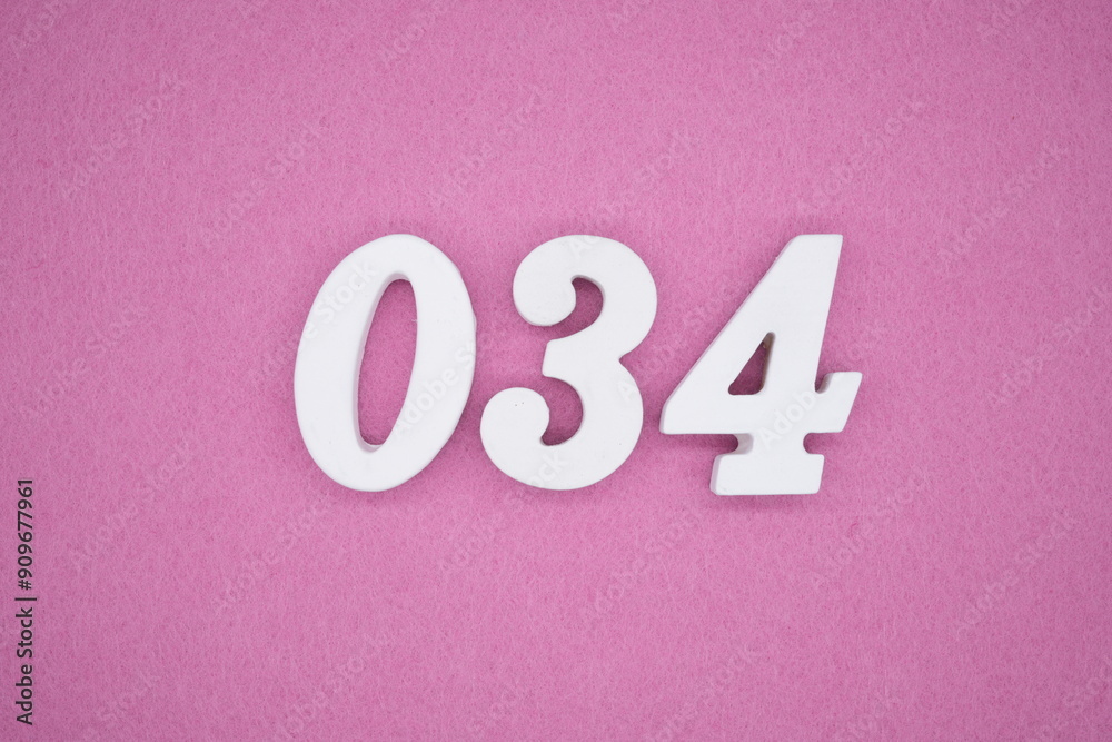 The numbers are made of white painted wood. Laying on the floor was pink paper. The numbers are made of white painted wood. Laying on the floor was pink paper.