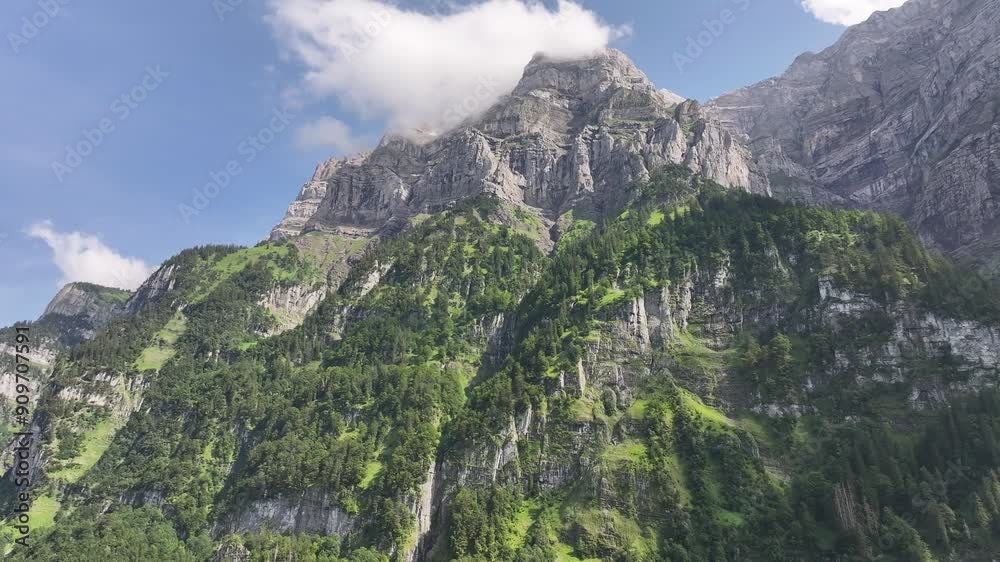Aerial view of a majestic mountain landscape in the Swiss Alps, featuring a serene lake in the valley, including Klöntal, Vorderglärnisch, and Glarus Süd, Switzerland, highlighting natural grandeur. Aerial view of a majestic mountain landscape in the Swiss Alps, featuring a serene lake in the valley, including Klöntal, Vorderglärnisch, and Glarus Süd, Switzerland, highlighting natural grandeur.