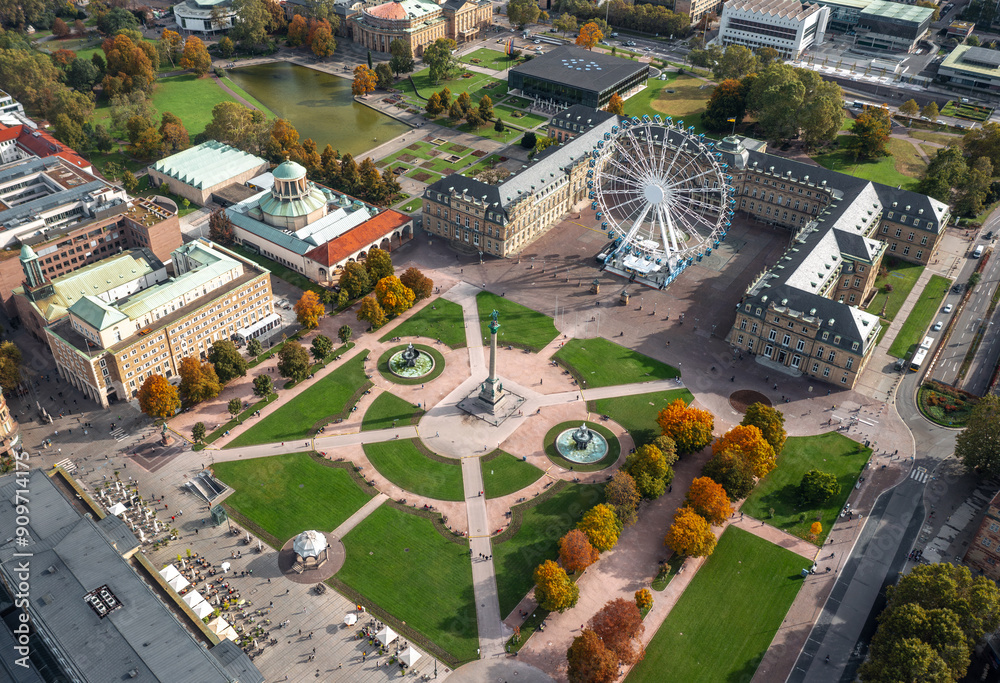 Beautiful autumn aerial view of Stuttgart Mitte, Baden-württemberg, Germany. Ferris wheel and Jubiläumssäule at Schlossplatz in front of Neues schloss