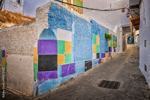 Colorful wall of a destroyed building facing on a narrow alley inside the Medina. Tangier city, Morocco. 