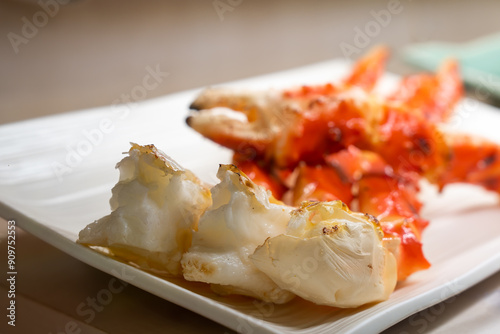 King crab legs grilled served on a white plate showcasing the tender and flavorful fresh seafood closeup crab meat photo