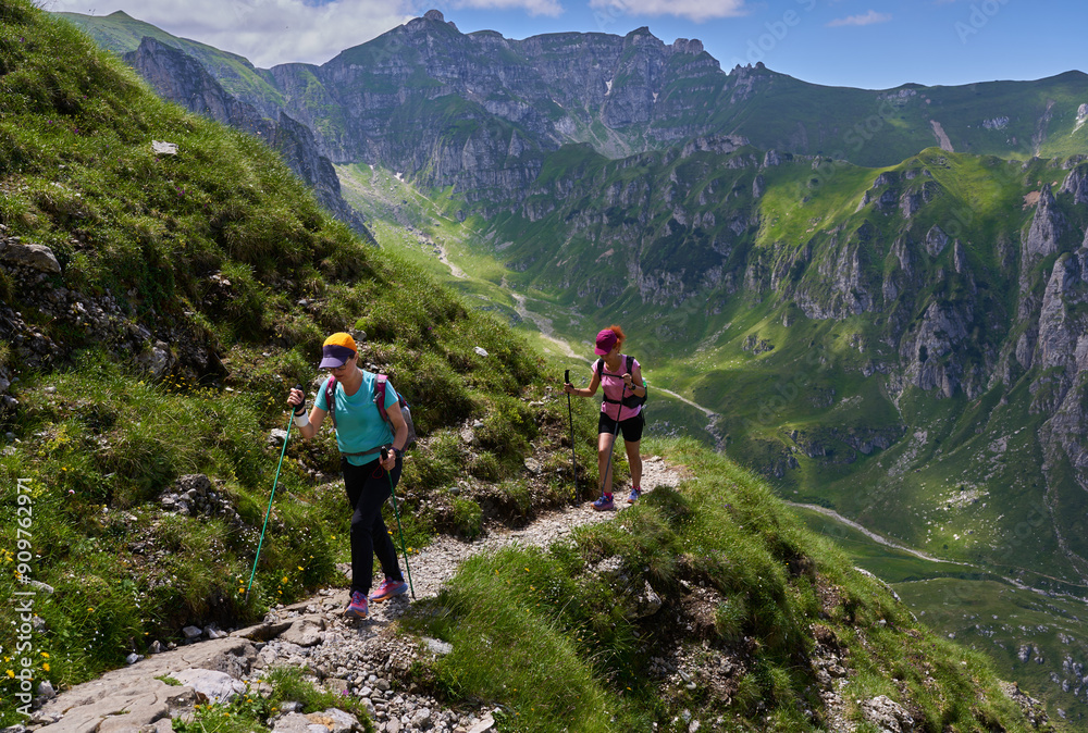 Hiker women with backpacks on a trail