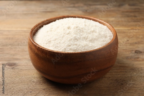 Fototapeta Naklejka Na Ścianę i Meble -  Organic coconut flour in bowl on wooden table, closeup
