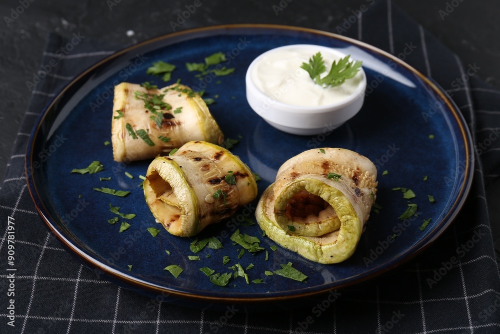 Tasty grilled zucchini slices served with sauce on table Tasty grilled zucchini slices served with sauce on table