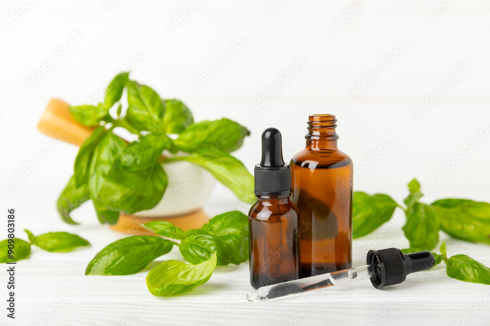 Basil essential oil on a textured wooden background. Basil essential oil and fresh leaves. Aromatherapy. Aroma oil. Medical herbs. Alternative medicine. Place for text. Copy space. Basil essential oil on a textured wooden background. Basil essential oil and fresh leaves. Aromatherapy. Aroma oil. Medical herbs. Alternative medicine. Place for text. Copy space.