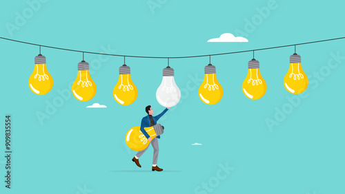 replacing outdated ideas or strategies for business success, businessman replaces a dead light bulb with a new one