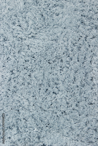 Vertical texture of faux fur as background, light blue, close up