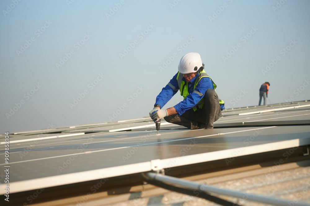 An engineer installs solar panels on the roof. An engineer installs solar panels on the roof.