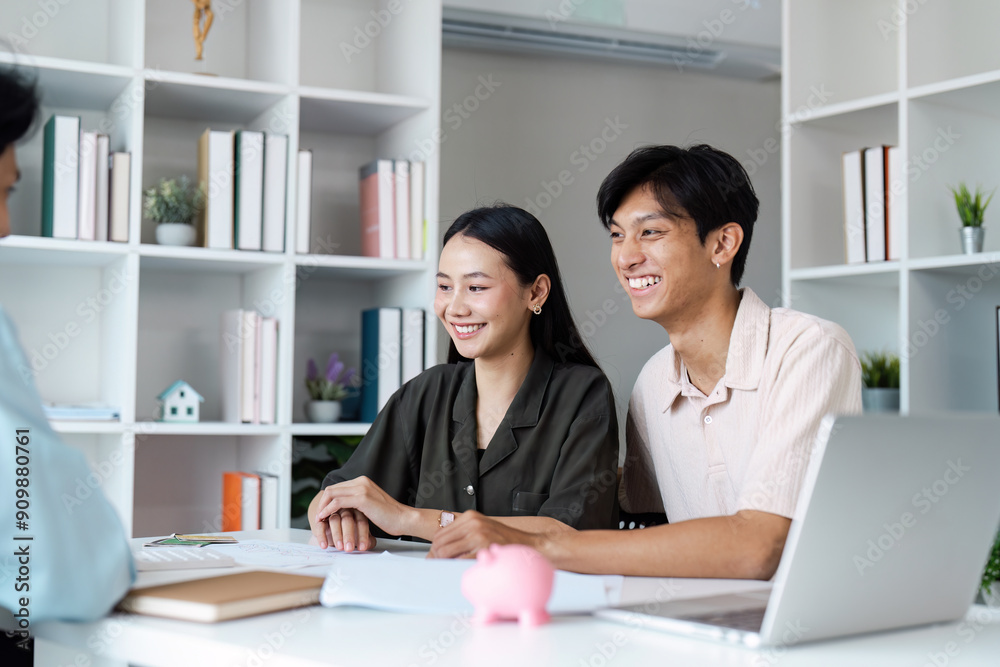 Young Couple Planning Savings and Investments with Financial Advisor in Modern Office Setting Young Couple Planning Savings and Investments with Financial Advisor in Modern Office Setting