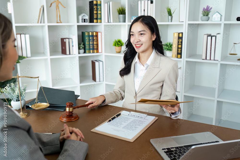 Professional Female Lawyer Discussing Contract with Client in Modern Office Setting Professional Female Lawyer Discussing Contract with Client in Modern Office Setting