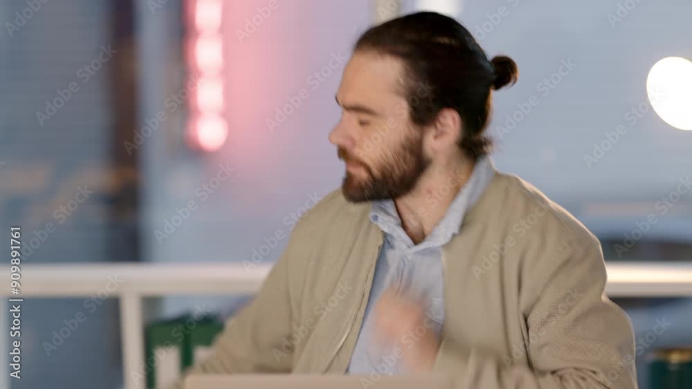 Angry young businessman feeling stress and the pressure of deadlines while working late on his laptop. Web developer getting upset about failure and mistake while banging his desk in frustration