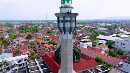 Drone shot of islamic mosque tower with landscape of house building