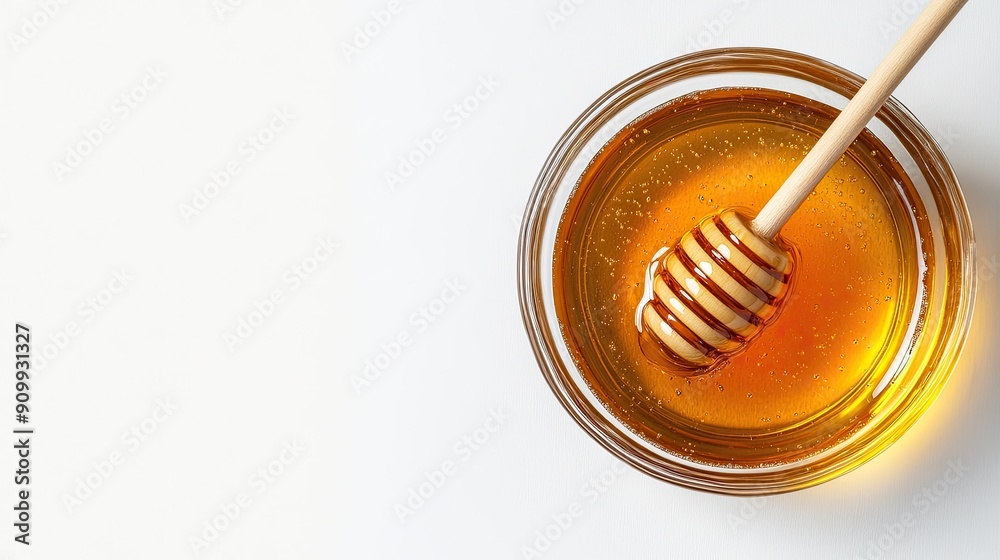 Aerial view of a glass bowl of honey with a honey dipper, isolated on a white background, emphasizing the rich, golden color Aerial view of a glass bowl of honey with a honey dipper, isolated on a white background, emphasizing the rich, golden color