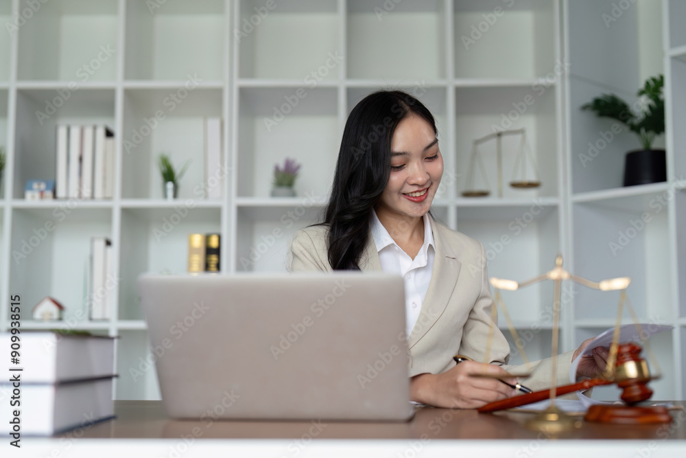 Professional Female Lawyer Working at Desk with Laptop and Legal Documents in Modern Office Professional Female Lawyer Working at Desk with Laptop and Legal Documents in Modern Office