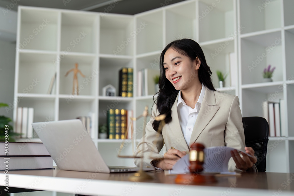 Professional Female Lawyer Working at Desk in Modern Office with Legal Documents and Laptop Professional Female Lawyer Working at Desk in Modern Office with Legal Documents and Laptop