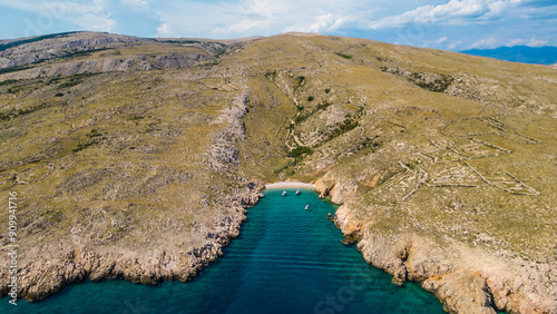 An aerial view of Dubna Beach, located near Baška on Krk Island, Croatia, captured by a drone. This beautiful beach is nestled along the island’s rugged coastline, featuring crystal-clear water photo