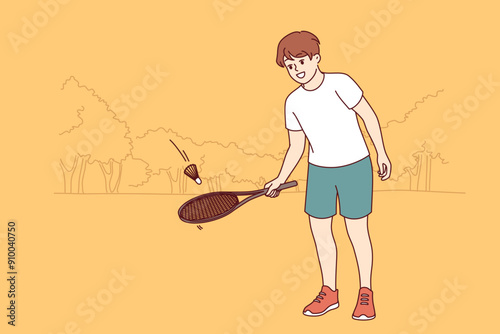 Little boy plays tennis in summer park, hitting ball with tennis racket and dreaming of becoming professional player. Happy child playing badminton as hobby to take mind off studies