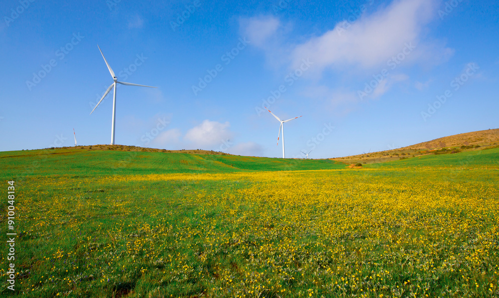 Wildmill standing on the field at mountain in blue sky Wildmill standing on the field at mountain in blue sky
