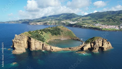 Aerial view of Ilheu de Vila Franco do Campo on a bright summer day, showcasing its turquoise lagoon and volcanic beauty off Sao Miguel, Azores, Portugal photo