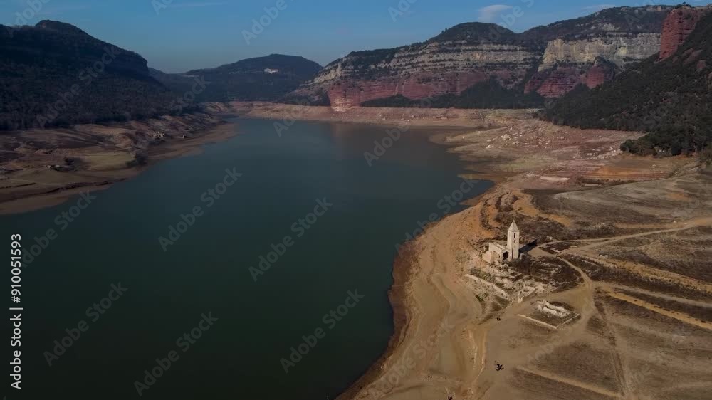 Aerial view os Sau water reservoir in Catalonia with old church with low water levels during drought. Concept of climate change and water crisis