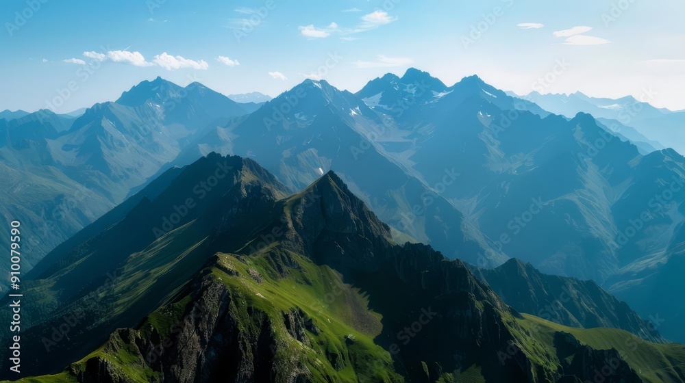 Aerial view of majestic mountain range with snow-capped peaks and lush green slopes under a clear blue sky. Aerial view of majestic mountain range with snow-capped peaks and lush green slopes under a clear blue sky.