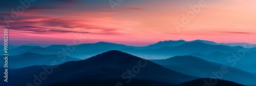 Silhouette of mountains against a pink and blue sunset sky.