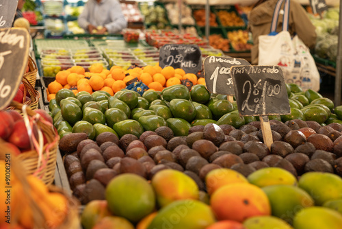 Avocados, mangos  and other tropical fruits presented at the weekly market in Rotterdam. Healthy food, ripe, ready to eat, market stall, trader, price tag, food.