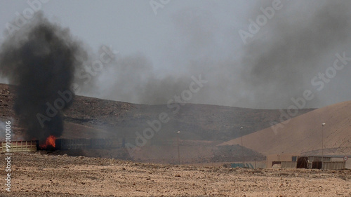 Residues burning violently at a recycling treatment plant. Medium Shot. Concept of environmental disaster due to the manufacture and handling of toxic substances.