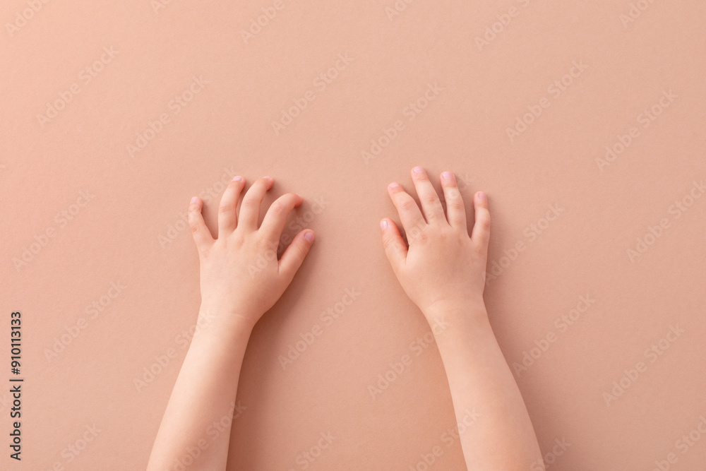 Small child hands on beige background top view. Skin care, family, playing and education template concept. Small child hands on beige background top view. Skin care, family, playing and education template concept.