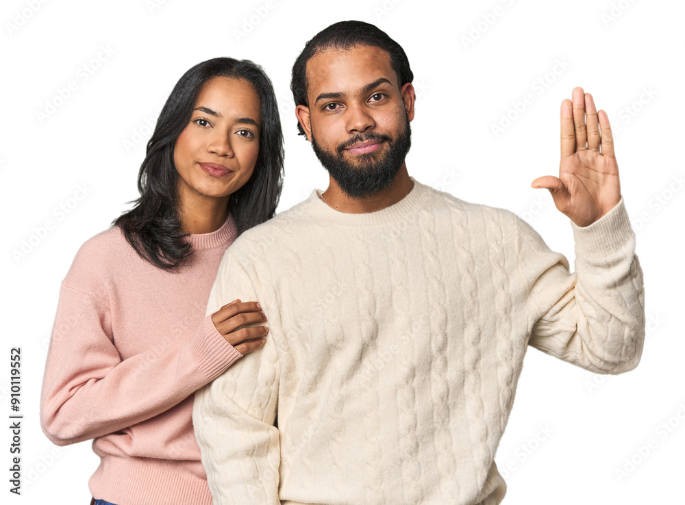 Young Latino couple in studio smiling cheerful showing number five with fingers. Young Latino couple in studio smiling cheerful showing number five with fingers.