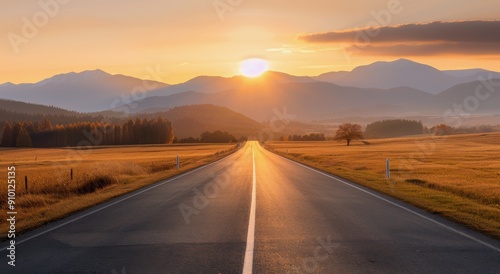 Scenic Autumn Road Surrounded by Mountains and Trees at Sunset