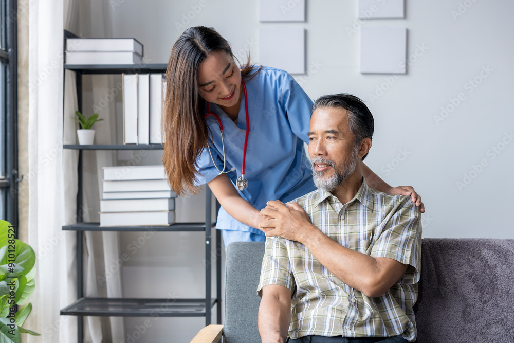 Obraz premium Young female nurse comforting elderly male patient at home