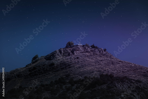 Night view of the Catholic Hermitage of the Three Juanes in Atarfe, Granada province, Spain. Photograph from the base of the Three Juanes hill shows the small hermitage under a starry night sky photo