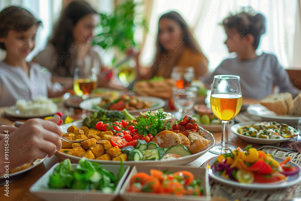 Family enjoying meal together with fresh vegetables and drinks Family enjoying meal together with fresh vegetables and drinks